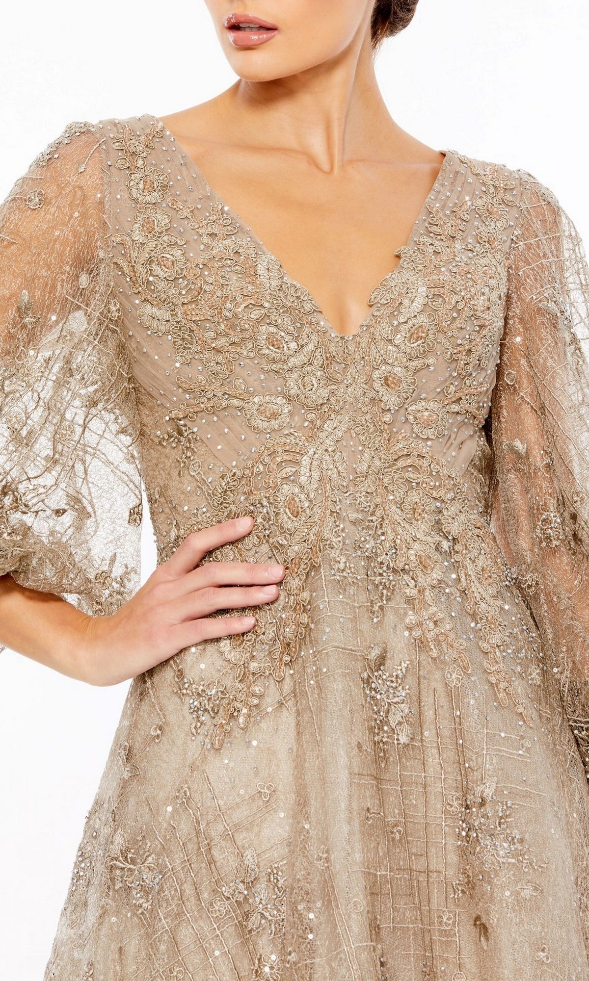 Woman wearing the Long Formal Dress 20283 by Mac Duggal, an ornate beige gown with intricate beadwork, a V-neckline, and sheer puff sleeves for a timeless, elegant look.